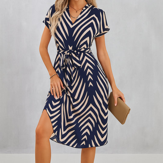 Irregular striped midi dress with asymmetrical hem and geometric pattern.