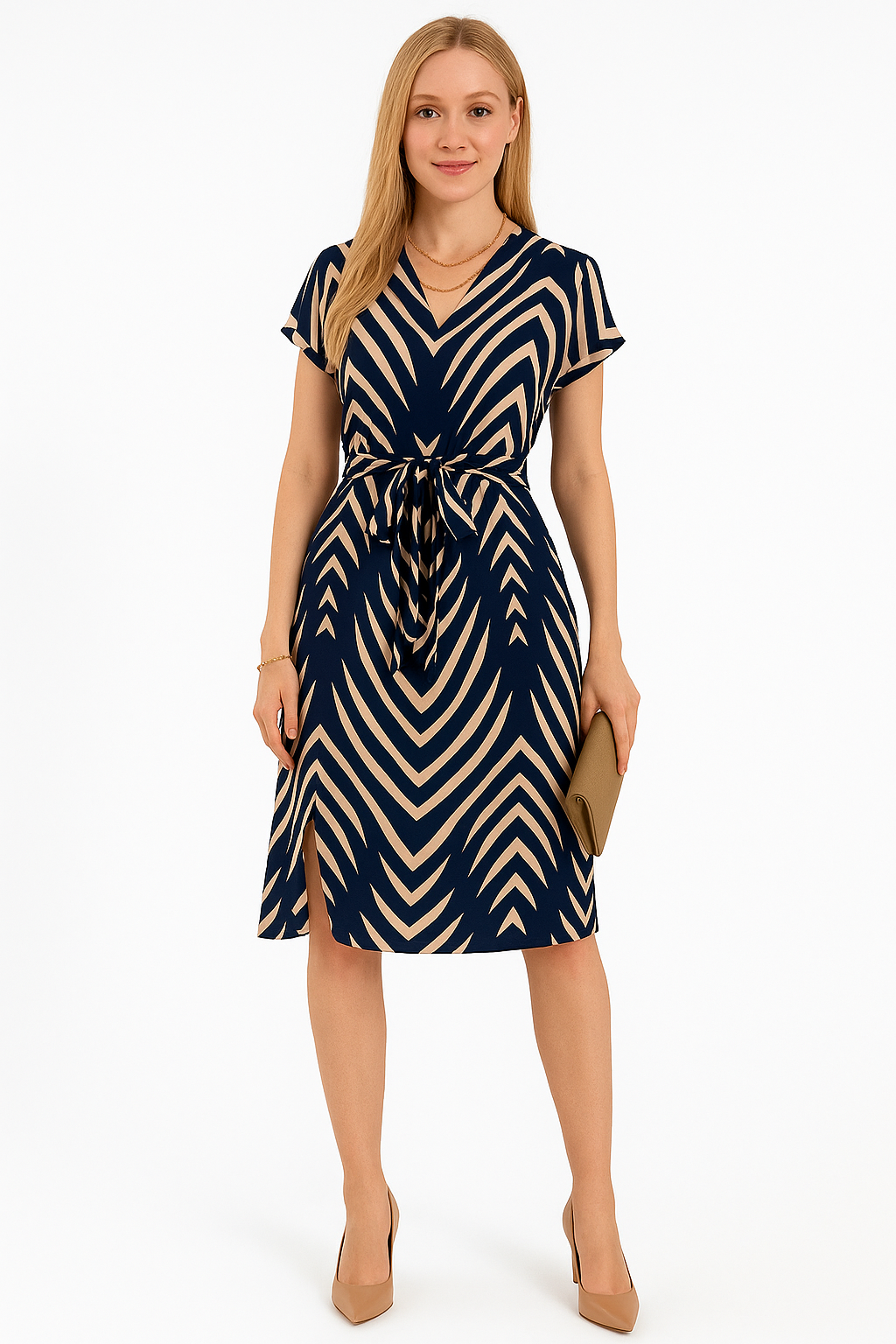 Woman wearing navy and beige striped midi dress with V-neck and tie waist, styled with nude heels and clutch, standing against white background