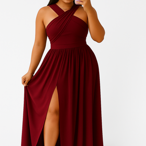 Woman wearing a burgundy SunGlow lightweight summer sleeveless dress with halter neck and flowy skirt with side slit, taking a mirror selfie