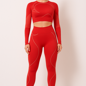 Woman wearing red TrendFlex Fitwear sport suit yoga set with long sleeves and high-waisted leggings, standing against a plain background.